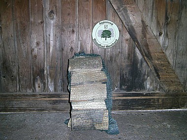 Netted seasoned hardwood logs.